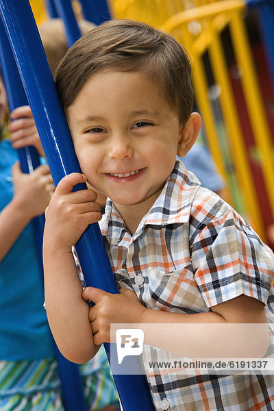 Mixed race boy playing in playground