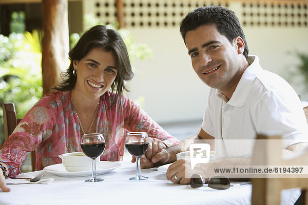 Couple drinking red wine in cafe