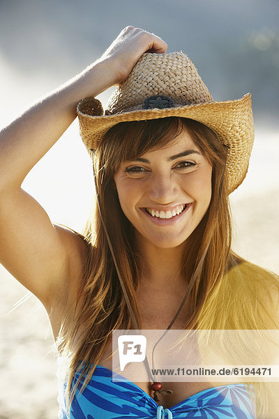 Smiling woman in straw cowboy hat