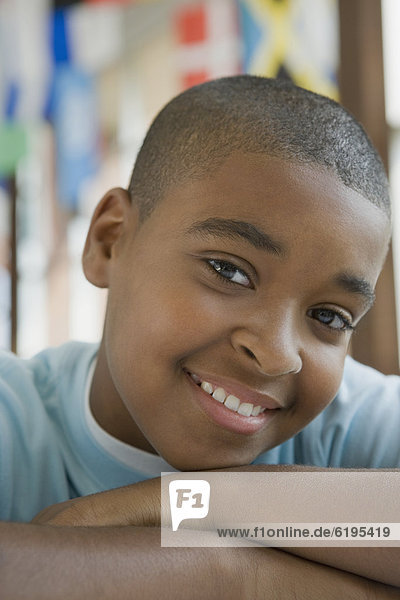 Mixed race boy with arms crossed