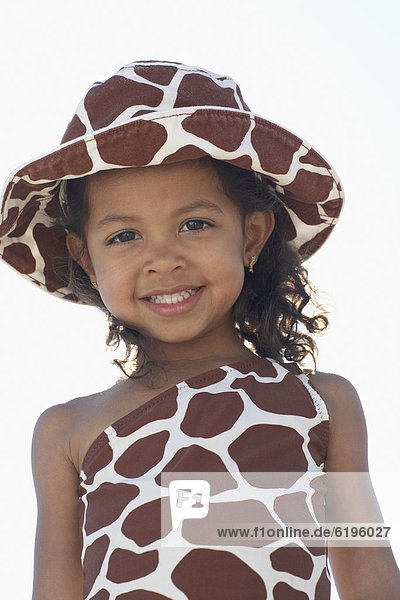 Young mixed race girl in bathing suit and hat