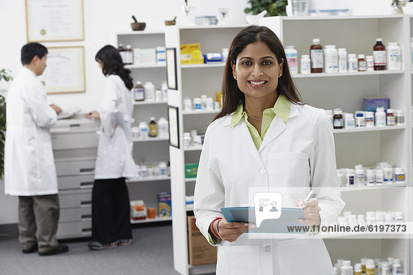 Portrait of Indian female pharmacist in pharmacy