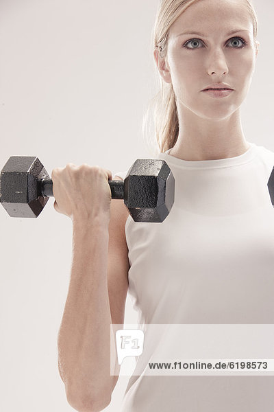 Caucasian woman exercising with dumbbells