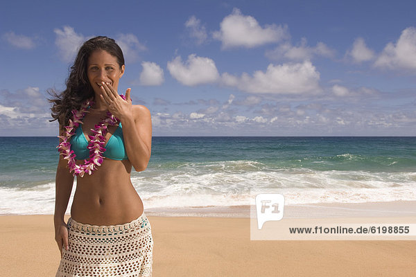 Pacific Islander woman laughing at beach