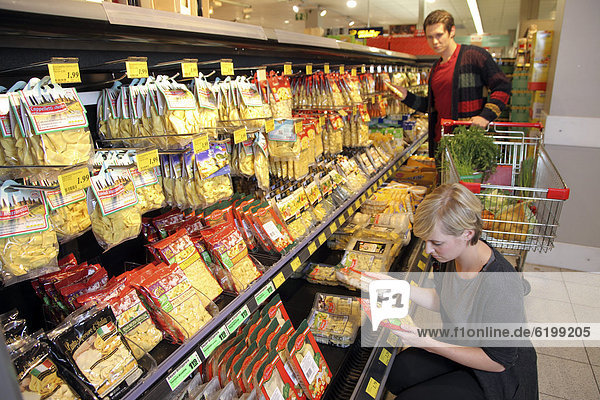 Customers standing in front of the refrigerated counter with fresh pasta  pasta products  food hall  supermarket  Germany  Europe