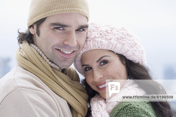 Portrait of Hispanic couple wearing winter clothing