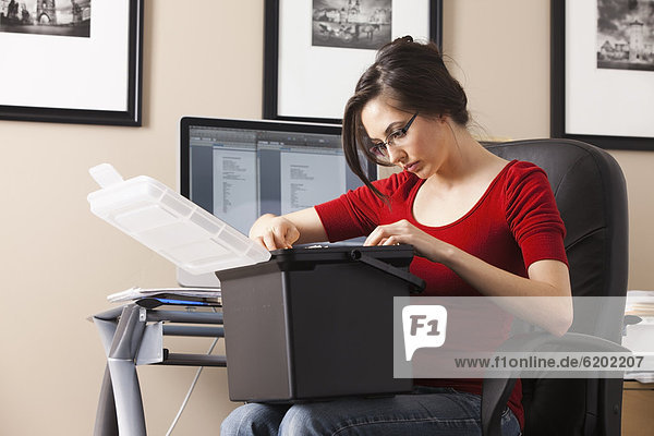 Caucasian woman working at desk in home office