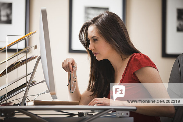 Caucasian woman working at desk in home office