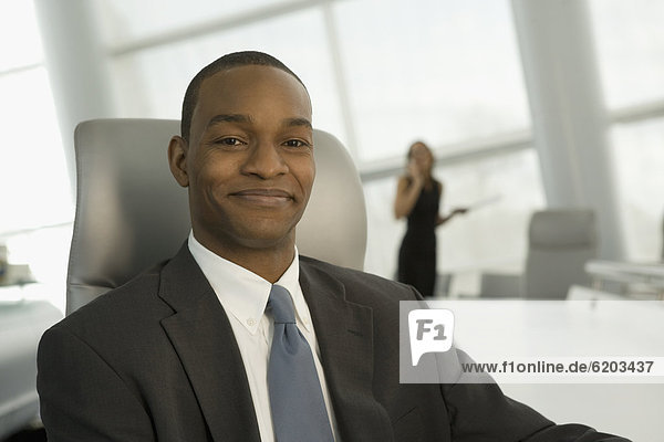 Close up of African businessman in conference room smiling