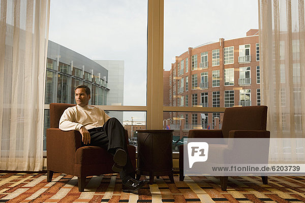 Businessman sitting in hotel waiting area