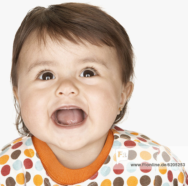 Close up of laughing hispanic baby girl