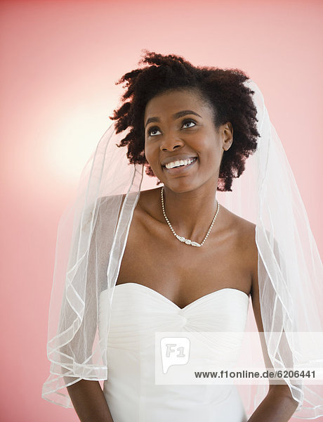 Smiling Black bride in wedding dress