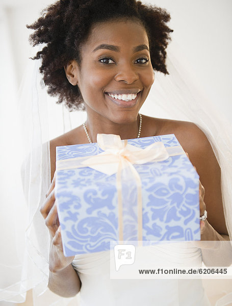 Black bride holding wedding gift