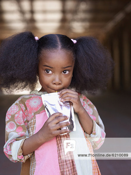 African girl drinking juice