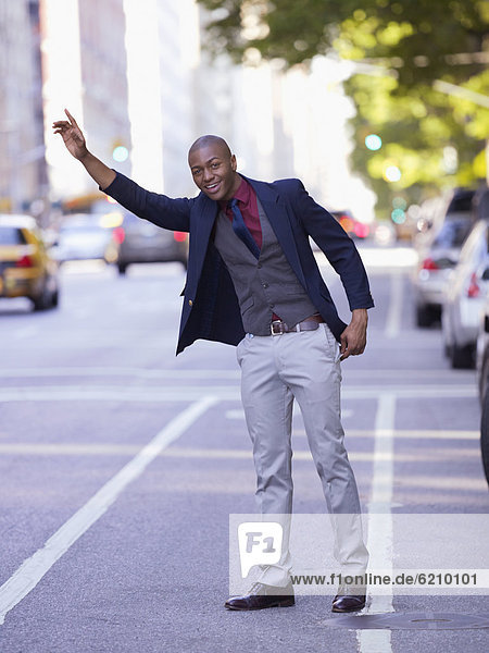 African businessman hailing taxi
