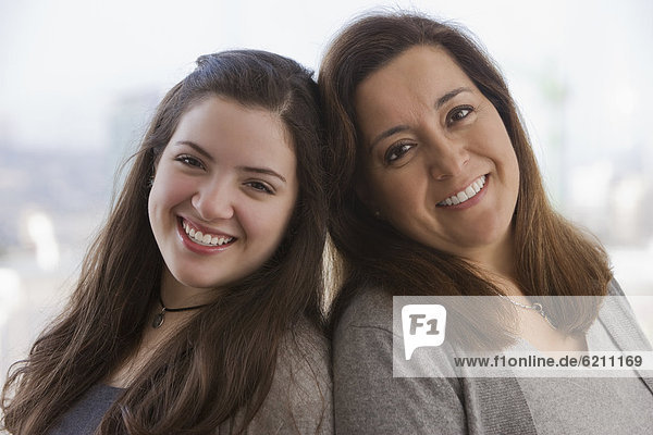 Smiling Chilean mother and teenage daughter