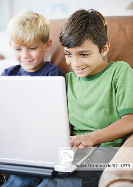 Boys using laptop together