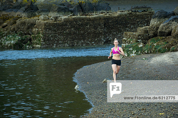 Caucasian woman running near lake