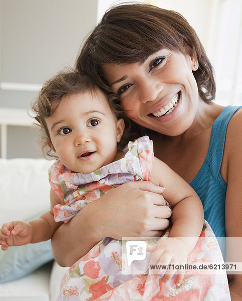 Hispanic mother holding baby girl