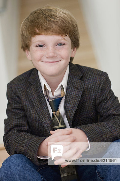 Smiling Caucasian boy in suit