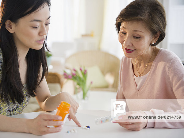 Japanese daughter explaining  medication to mother