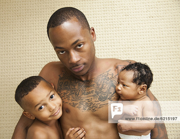 Tattooed father holding children