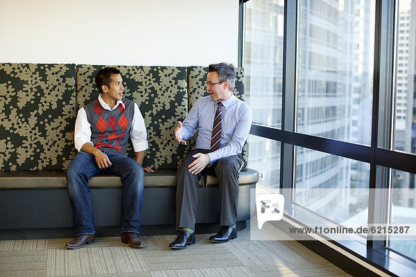 Businessmen talking together in office lobby
