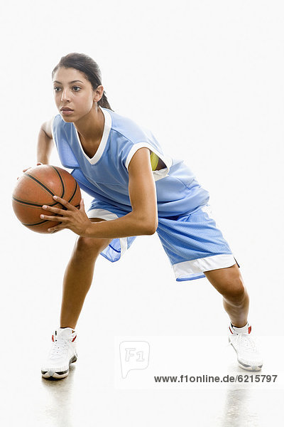 Mixed race woman playing basketball