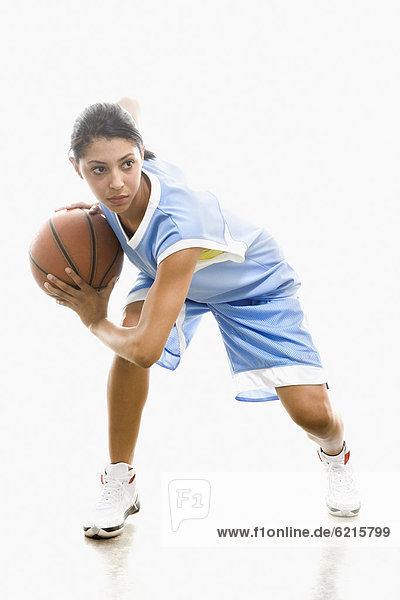 Mixed race woman playing basketball