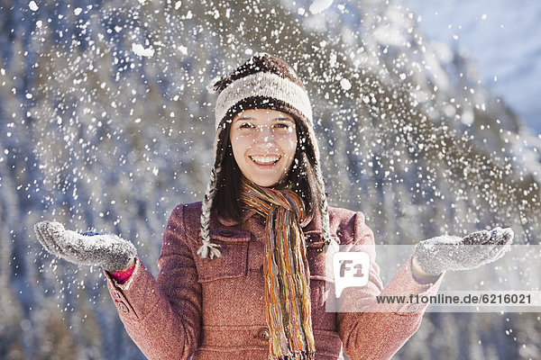 Caucasian woman standing in snowfall