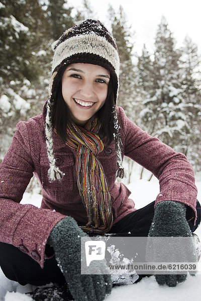 Caucasian woman sitting in the snow