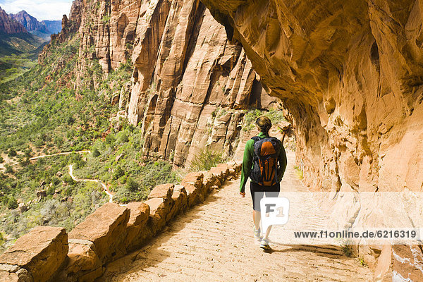 Persian woman hiking on canyon path