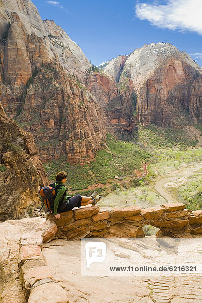 Persian woman sitting on canyon path