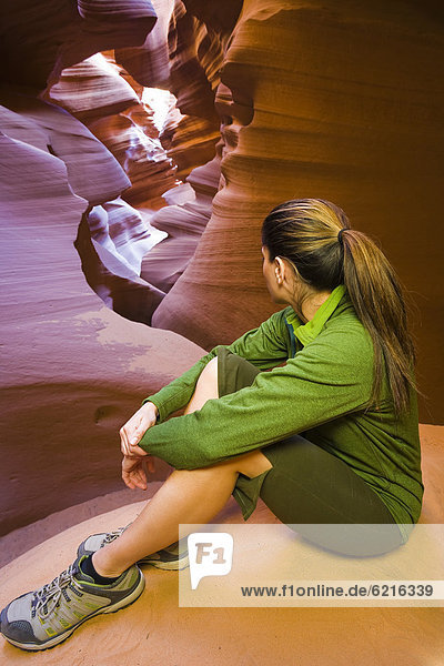 Persian woman sitting in canyon
