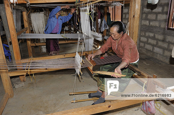 Weaver working on a hand loom in a silk factory near the town of Phansavan  Laos  Southeast Asia  Asia