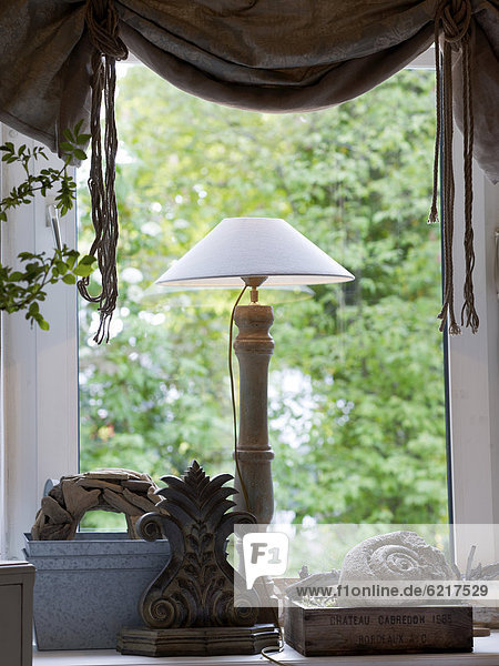 Still life  window with a shade lamp and decorative accessories  stylish environment