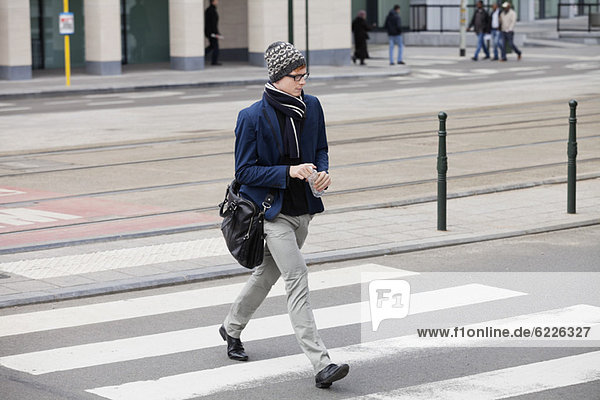 Businessman crossing the road