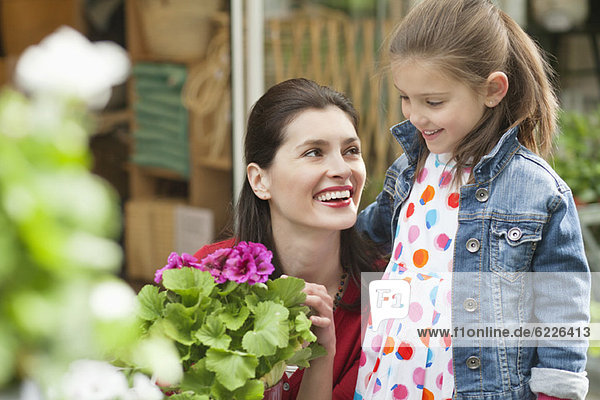 Woman and her daughter looking at flowers in a flower shop