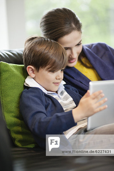 Woman and her son looking at a digital tablet