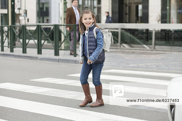 Schoolgirl crossing a road