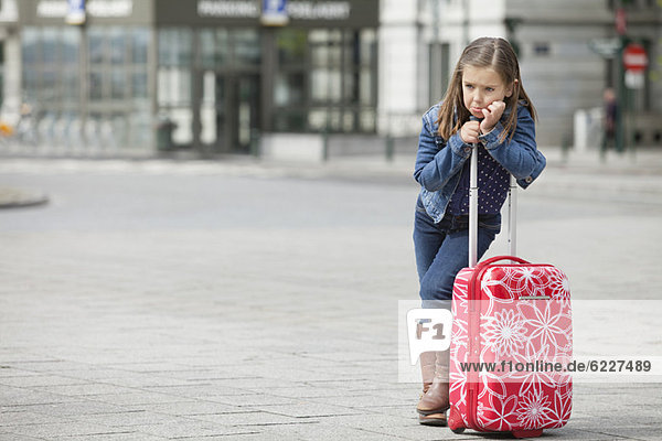 Girl standing with her luggage