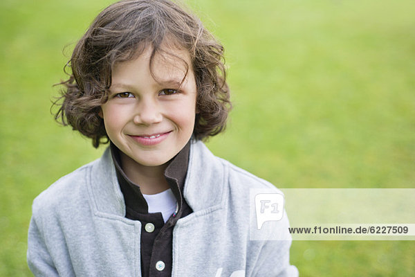 Portrait of a boy smiling in a field