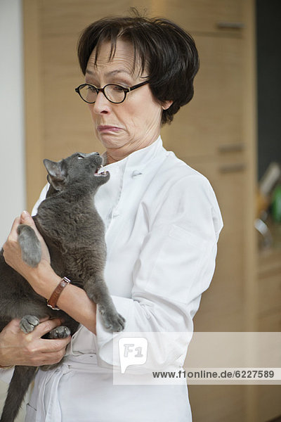Cat snarling on a woman