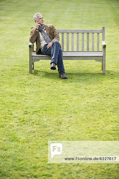 Man sitting on a bench and thinking in a park
