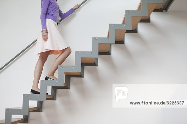 Woman moving up stairs