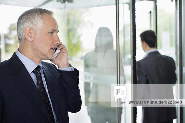 Businessman talking on a mobile phone in an office