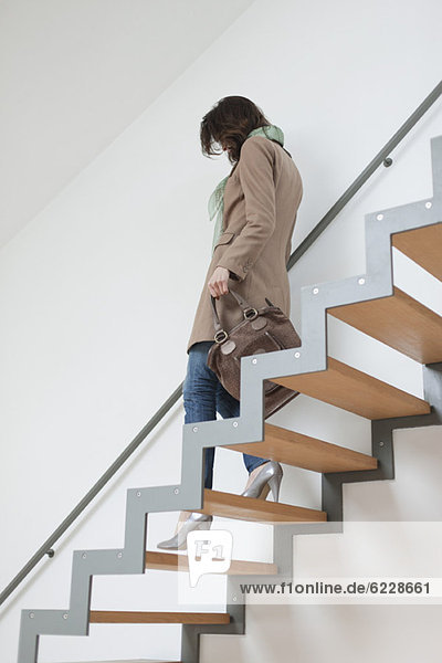 Woman moving down stairs