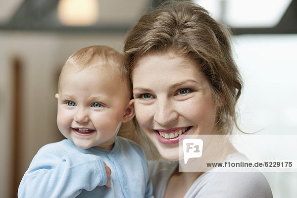 Close-up of a woman smiling with her baby girl
