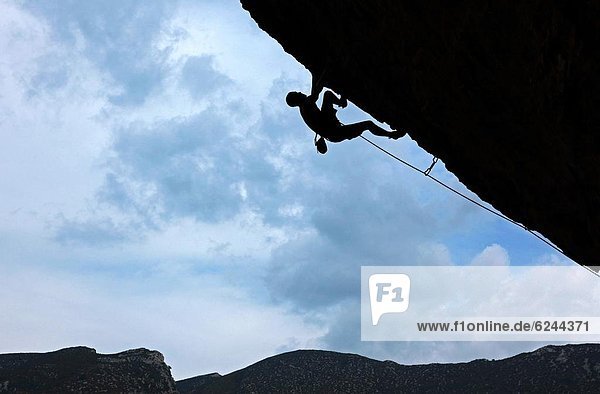 A climber tackles a severely overhanging route in the caves of the Mascun Gorge  Sierra de Guara mountains  Aragon  Spain