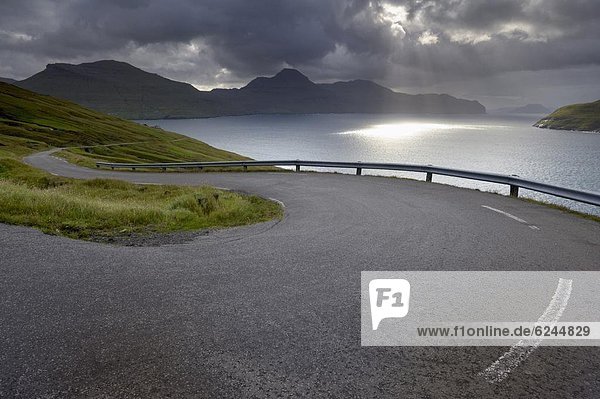 Winding road near Kvivik  and Vestmannasund between Vagar on the right  and Streymoy islands  from Streymoy  Faroe Islands (Faroes)  Denmark  Europe